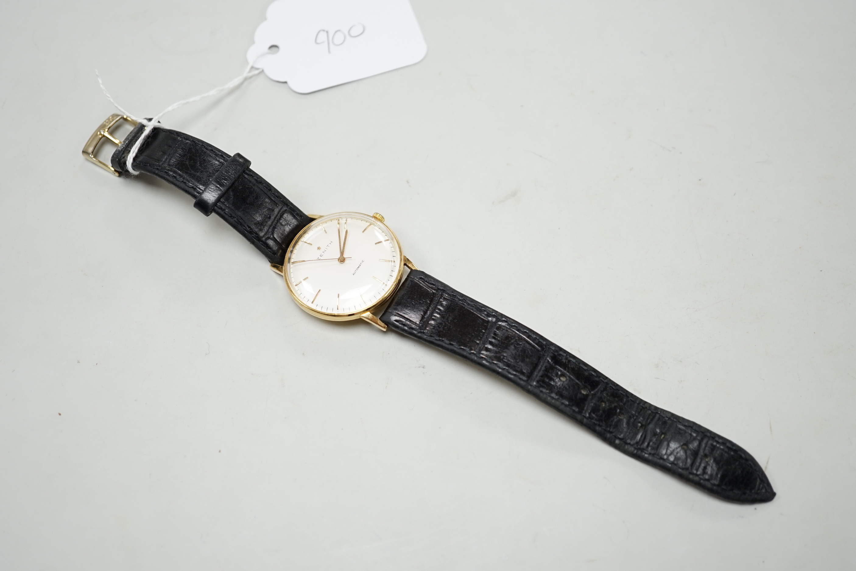 A gentleman's yellow metal (Swiss 750 mark) Zenith automatic wrist watch, with baton numerals, on associated leather strap, no box or papers.